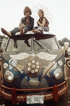 In this Aug. 1969 file photo, concert-goers sit on the roof of a Volkswagen bus at the Woodstock Music and Arts Fair at Bethel, N.Y.
