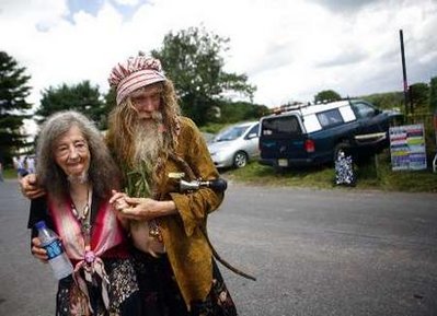 A couple known as Grandpa Woodstock and his wife Queen Estar walk in town near the site of the original Woodstock Music Festival in Bethel, New York
