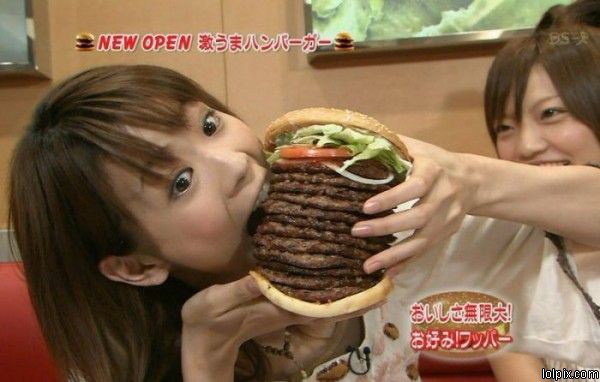 Small Women eating a big Burger