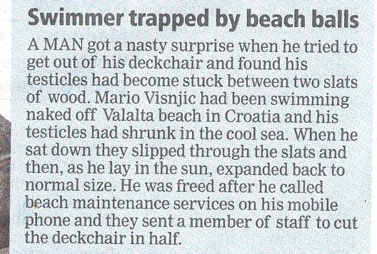 Swimmer traped by beach balls