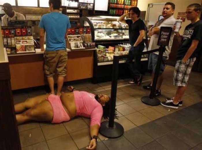 What the hell is happening here? Why is there a large black man passed out on the ground in Starbucks wearing a twelve year old white girls clothes? I have no idea, but nobody in the picture seems terribly concerned to find out.

Maybe its a public performing art piece about diabetes or something.

