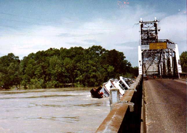 Tugboat rolls under bridge