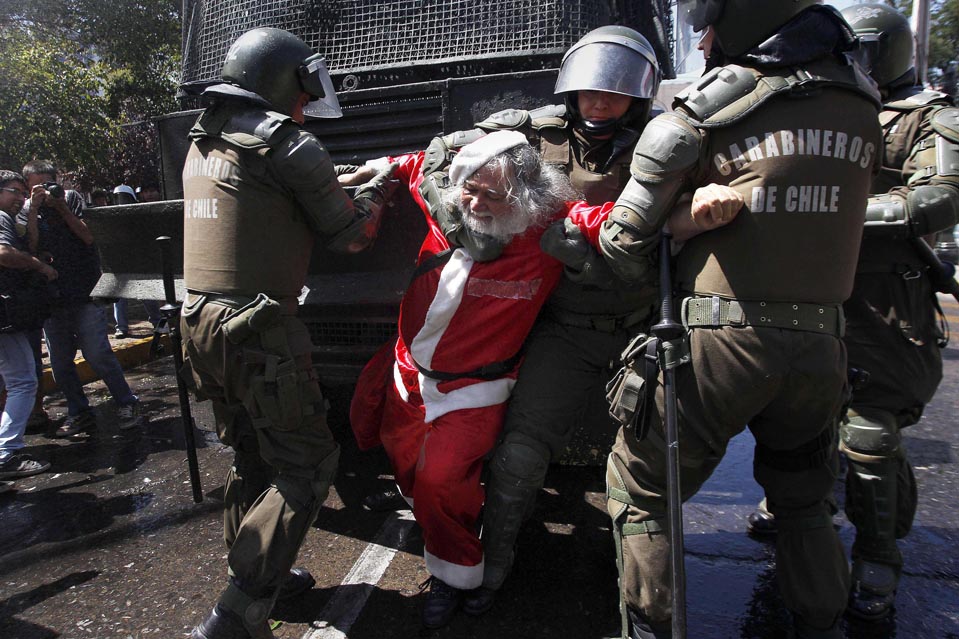 Santiago, Chile. December 22, 2011. Police arrested a demonstrator dressed as Santa Claus during a protest where protesters demanded changes in education funding.
