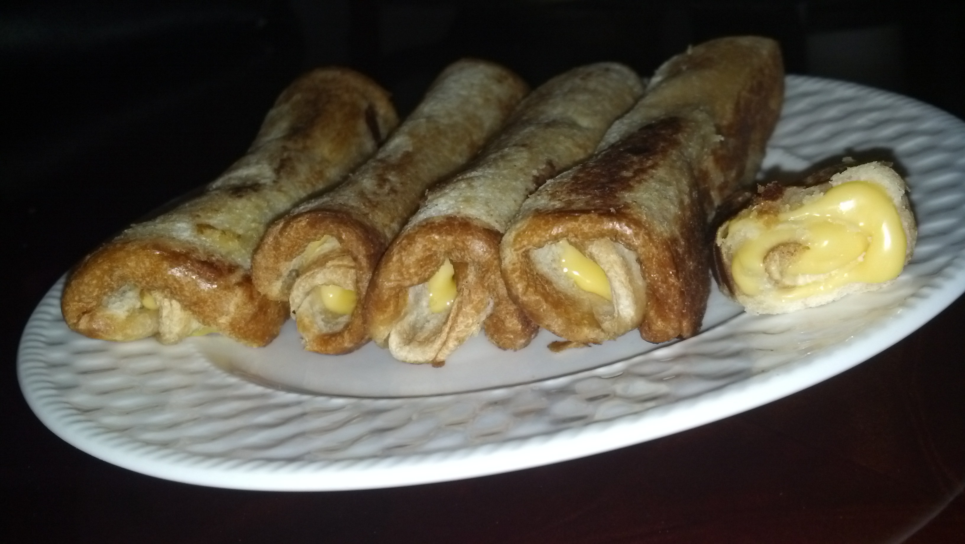 Sauteed rolled white bread with American cheese