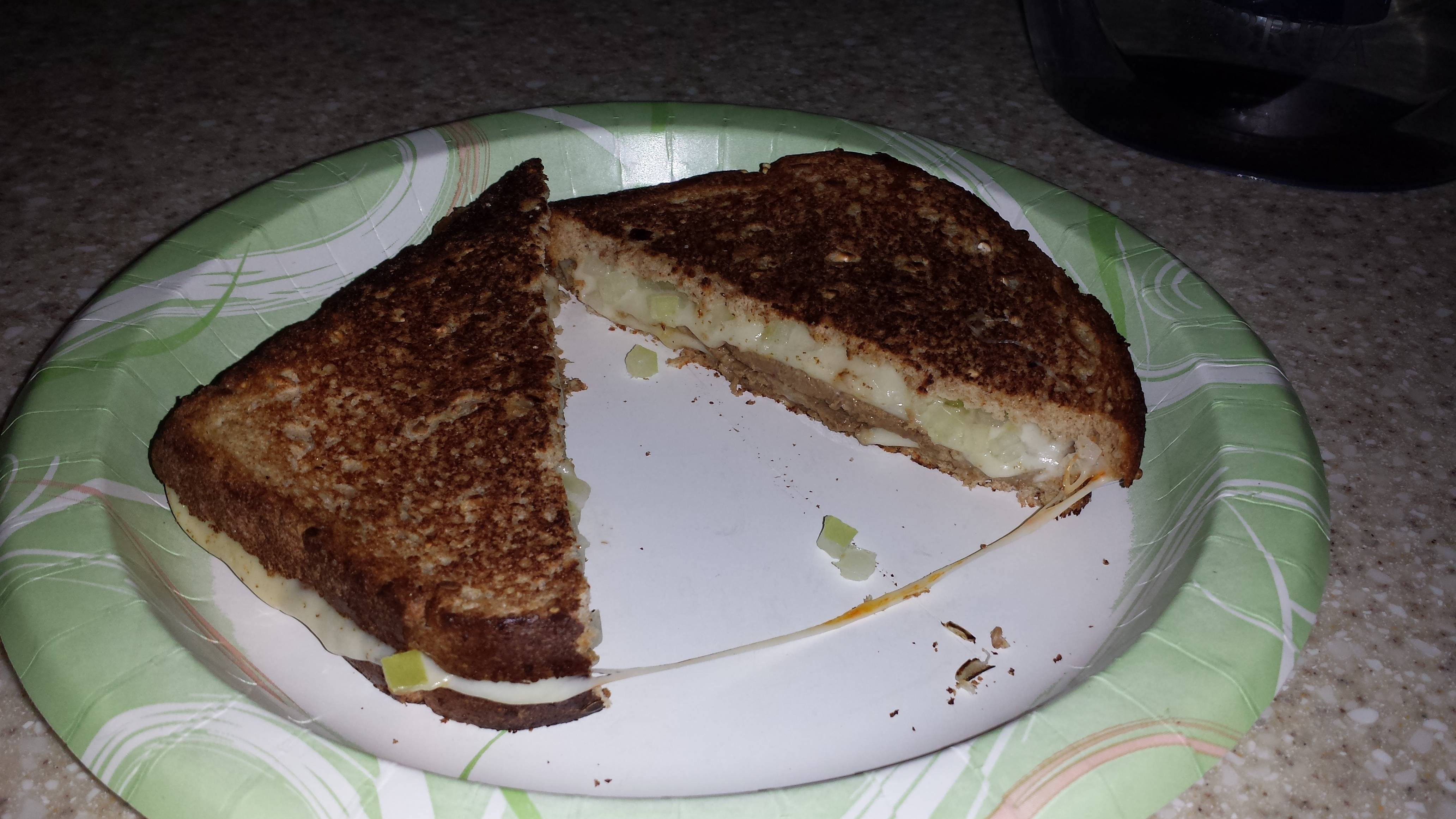 Roast beef and chopped onions with Muenster cheese on whole grain bread