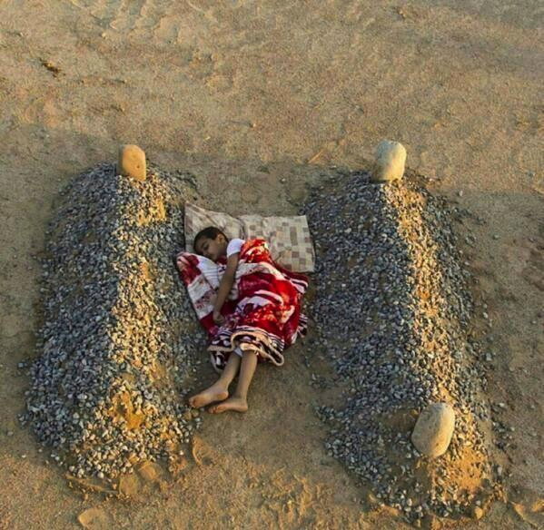 Orphaned Syrian Boy Sleeping Between His Parents' Graves. As this image went   viral people assumed it showed a child whose family had been killed during the conflict in Syria.