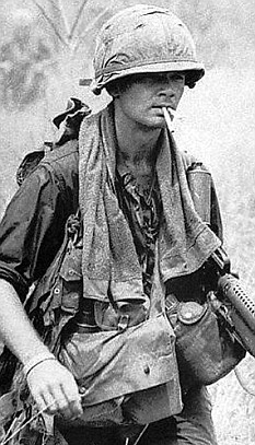 A GI smokes two cigarettes in Vietnam.