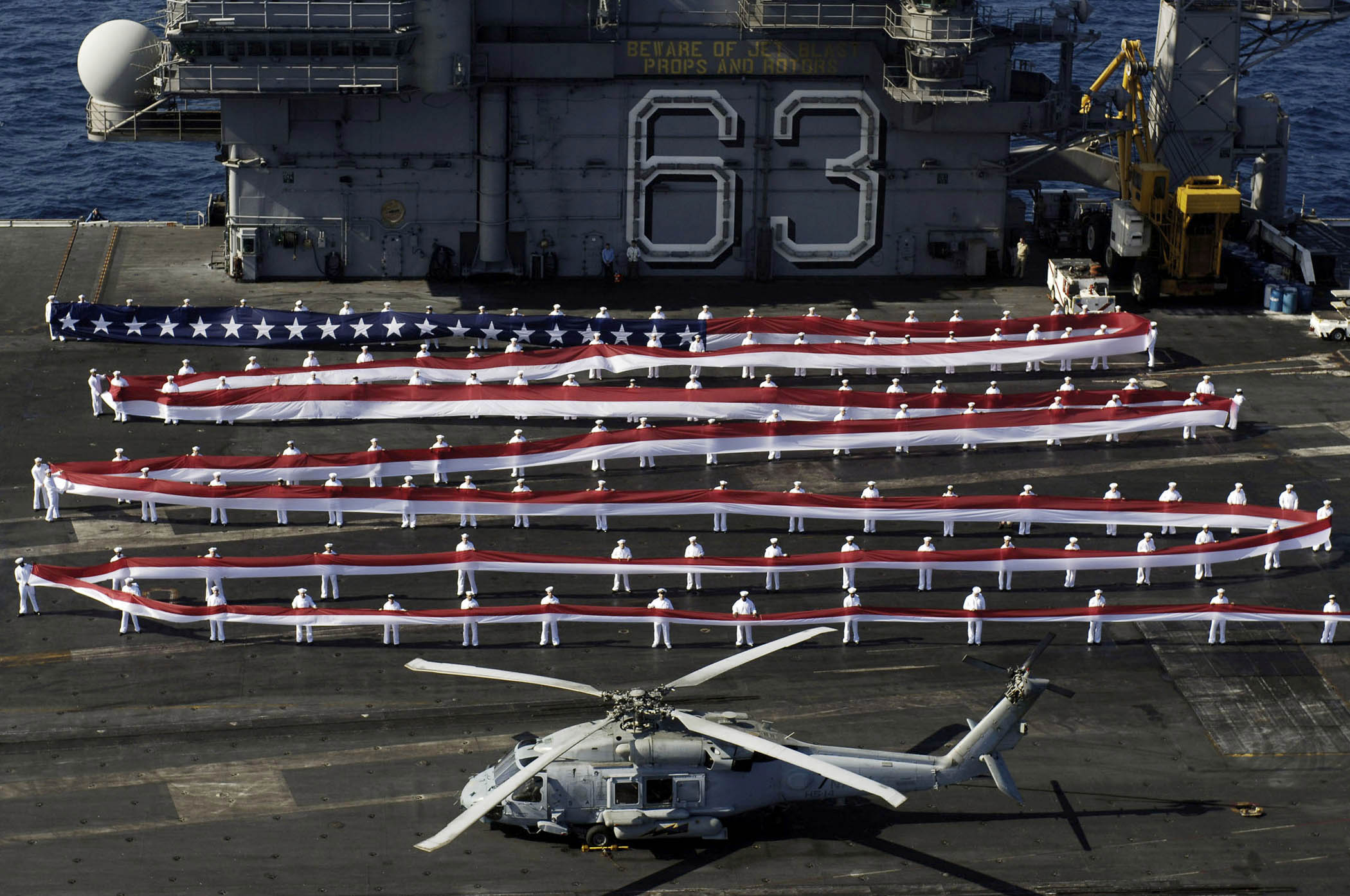 USS Kitty Hawk (CV-63) rendering honors.