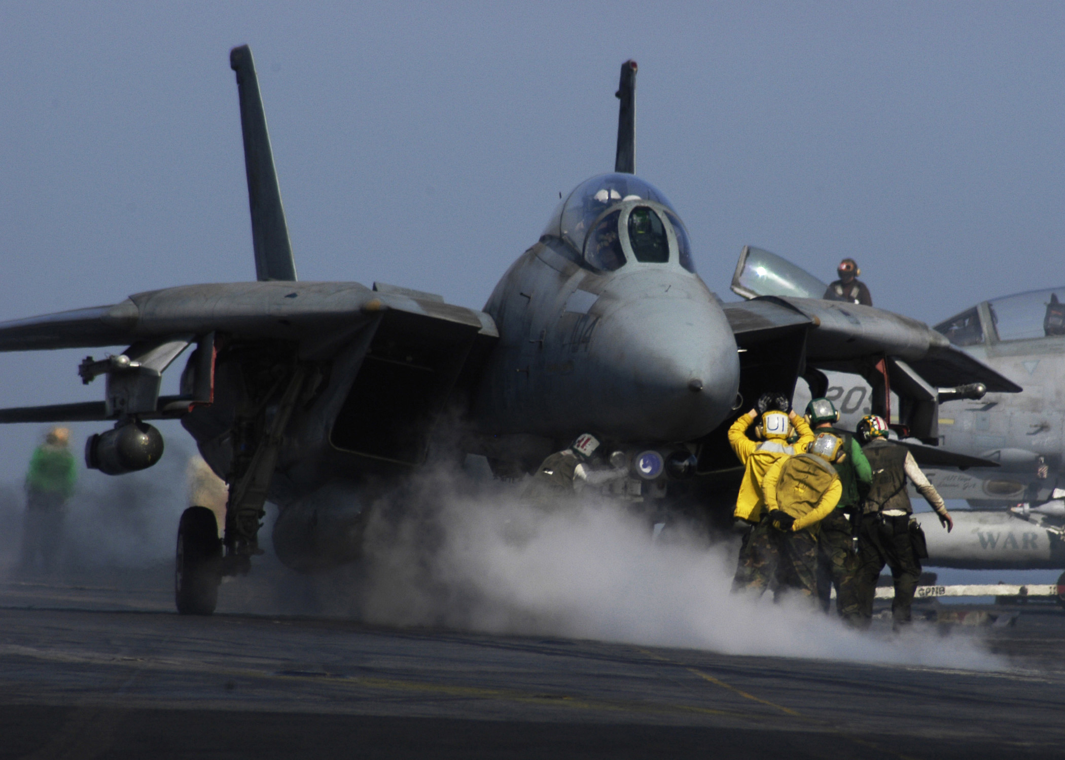 An F-14 Tomcat fighter arriving on the catapult.