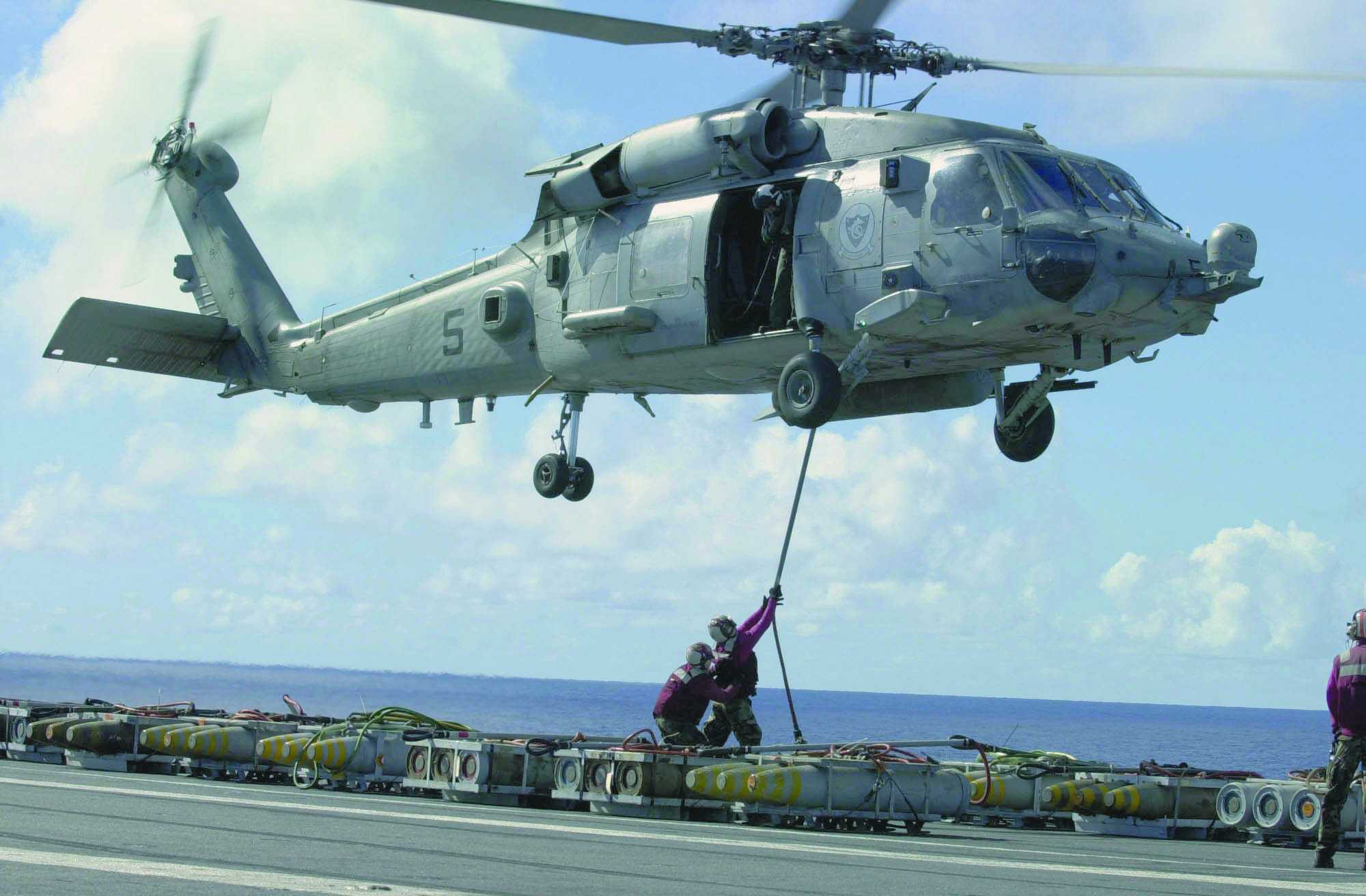 An SH-60 Seahawk performing VERTREP (Vertical Replenishment). Hundreds of transfers, one at a time.