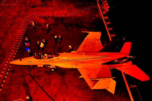 An F/A-18 Hornet refueling at night.
