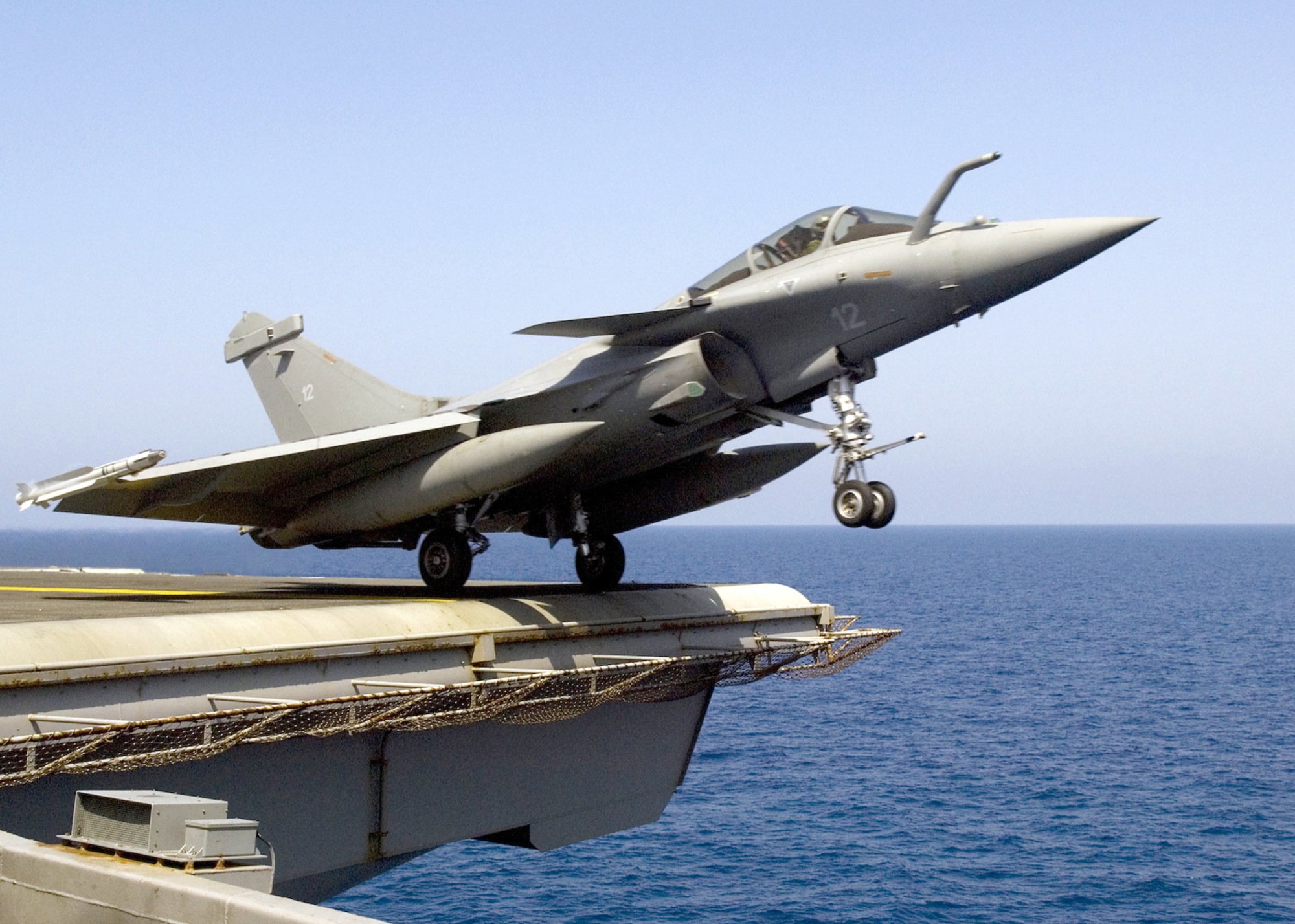 A Rafale aircraft leaving the flight deck of a carrier.