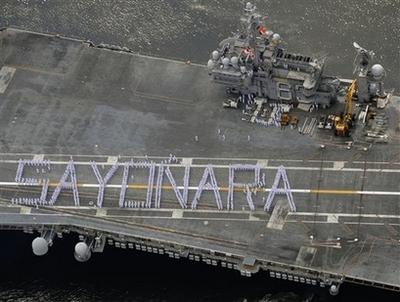 Sailors on the Kitty Hawk spell out 'Sayonara,' the Japanese word for a formal goodbye, as the ship leaves Japan forever.