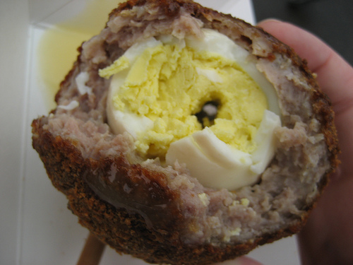Egg on a stick. An egg wrapped in sausage, with breadcrumbs, and of course deep fried!