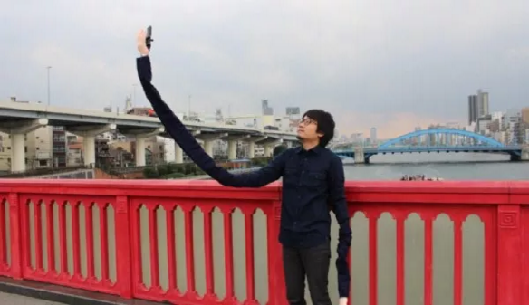 Man Embarrassed to Use Selfie Stick Creates Ridiculous Selfie Arms Instead