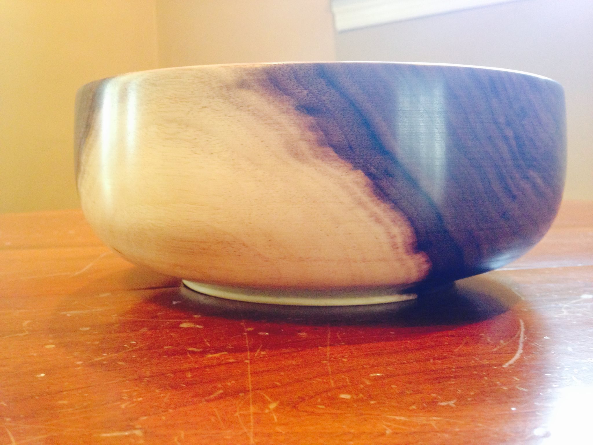 After your bowl has dried, you can remount, and finish turn. You're not taking much wood off at this stage, just getting rid of the bend and warping. Then you sand it from 100-1500 grit and finish. Here I used walnut oil and beeswax.