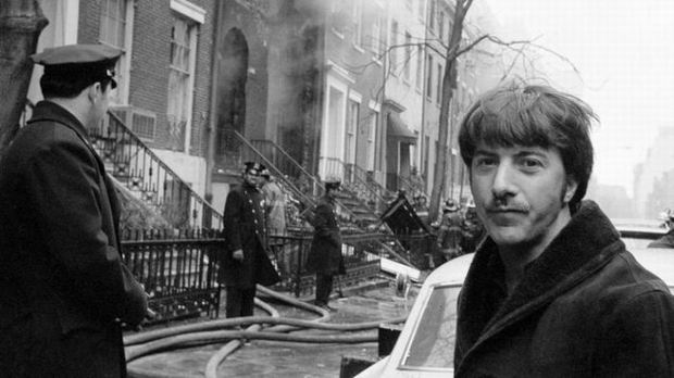 Dustin Hoffman taking a selfie with a burning building, 1970.