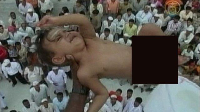 Babies Get Dropped From Buildings at Baba Umer Durga Shrine - In a local practice believed to bring prosperity and wealth to the families, babies are dropped about 50 feet from the top of a building to a sheet firmly held by men below. Near Sholapur, India, the ritual has been practiced for almost 700 years, and both Muslims and Hindus participate.