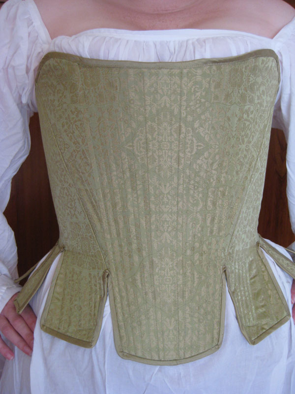 By the middle of the 16th century, these articles were extremely common among European women. This is around the time the "busk" was incorporated. A busk is a flat, long piece of metal, wood, horn, ivory or Whale bone (hence the term 'Bone-in Corset) and is sewn into the casing in order to hold it's shape.