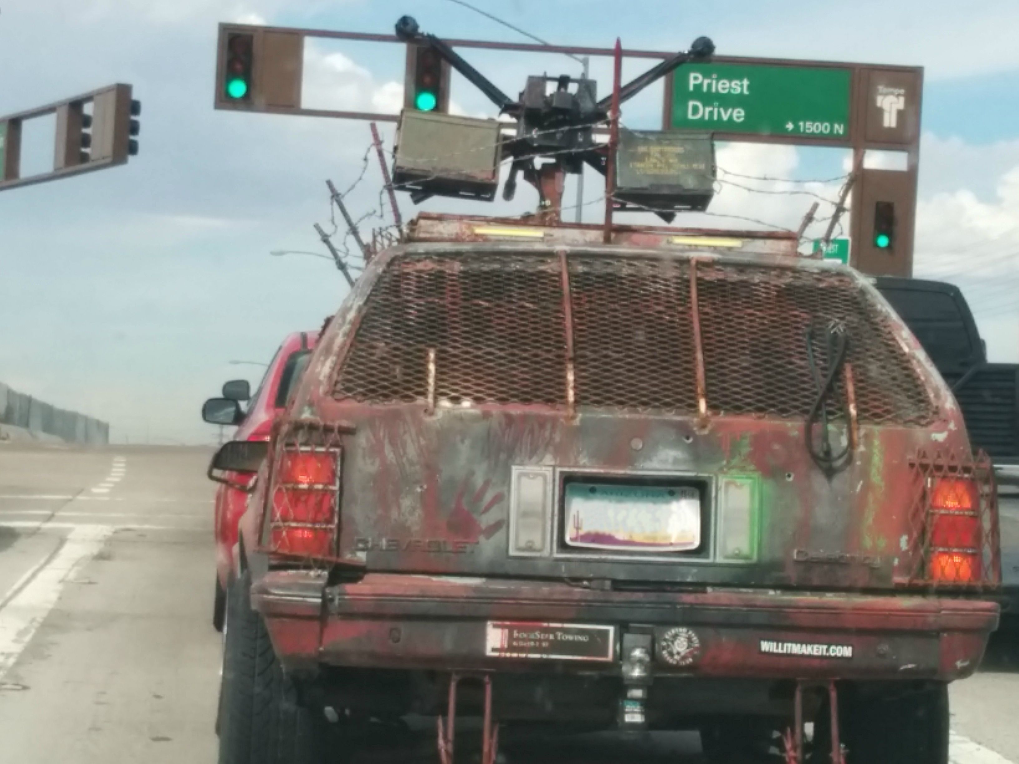 I pull off the freeway and pull up behind this beauty. At first I'm thinking, "what an ugly car". Then I see the hand print and my eyes flash to the turret mounted on top. WTF!