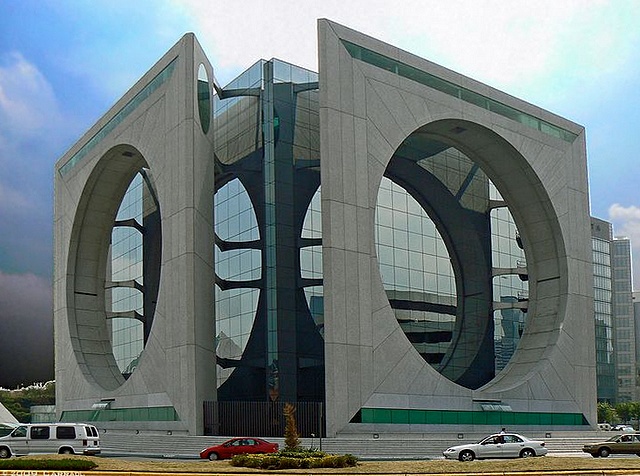 Calakmul, Mexico City. Agustin Hernandez Navarro made this building to look futuristic but people say it looks like a washing machine instead, they even call it La Lavadora (washing machine). There's also a small pyramid standing besides the Calakmul.