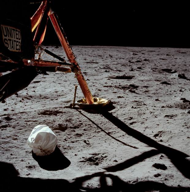 Neil Armstrong takes a picture of a garbage bag while saying "Dumping trash in the woods is too mainstream", The Moon 1969.