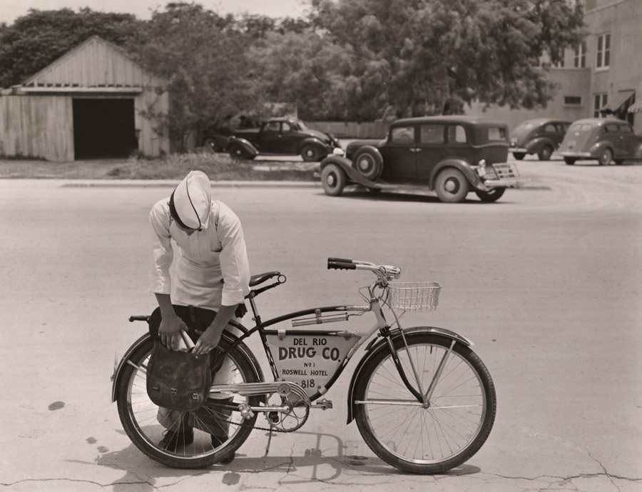 A Drugstore Cowboy prepares to make deliveries, 1938.