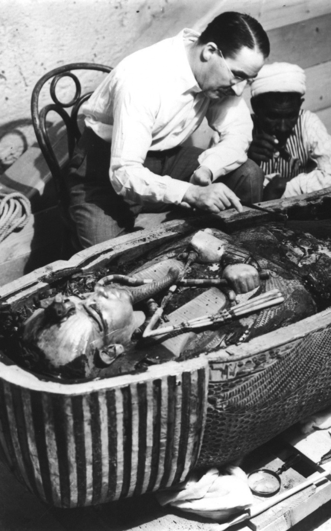 Howard Carter, a British archaeologist, examines the open sarcophagus of Tutankhamun, 1922.