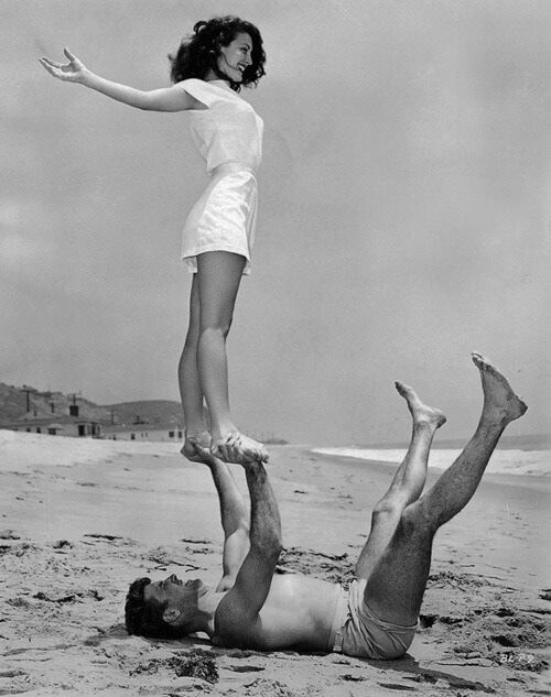 Ava Gardner and Burt Lancaster. Beach acro-yoga - 1946