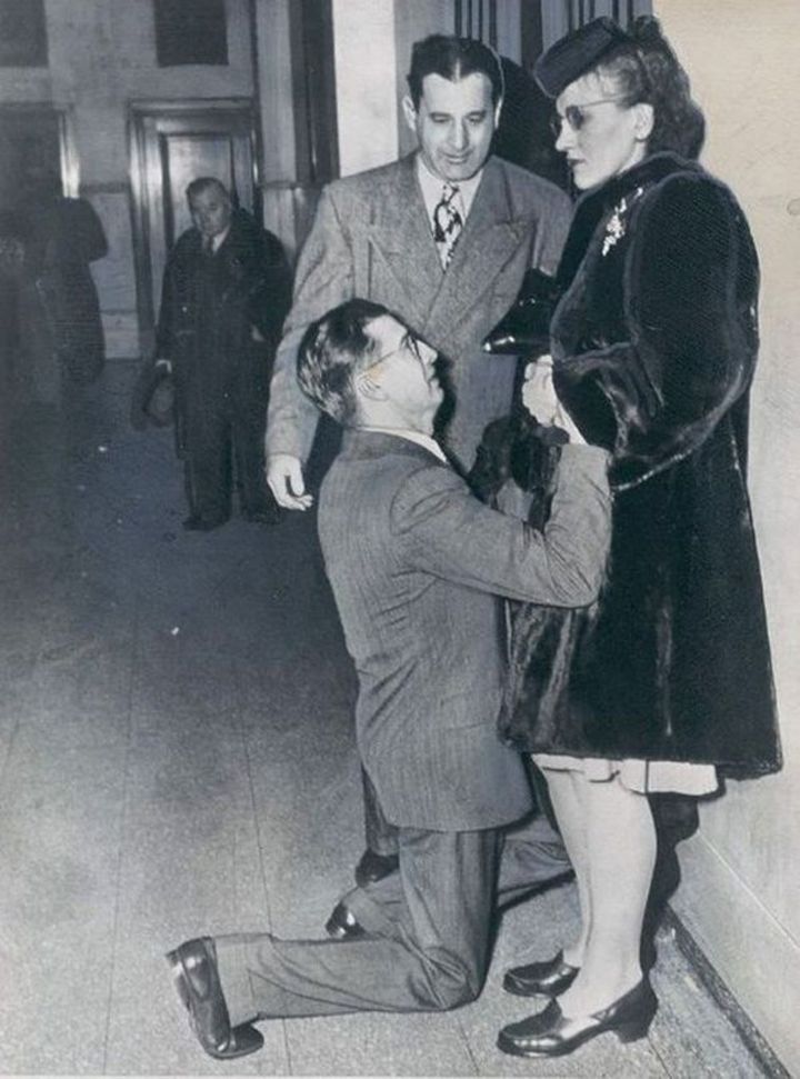 A man begging his wife to forgive him to avoid divorce, 1940s.