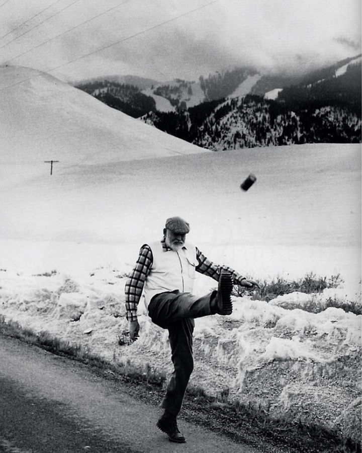 Ernest Hemingway kicking a can, 1959.