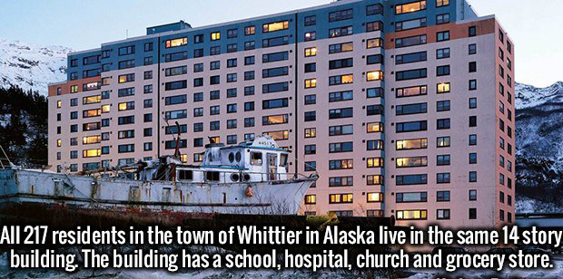whittier - Lumi Cris Idge 11 The" 0. All 217 residents in the town of Whittier in Alaska live in the same 14 story building. The building has a school, hospital, church and grocery store.