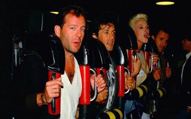 Movie set photo of Bruce Willis, Sylvester Stallone and Brigitte Nielsen on a roller coaster, 1987. It was a catastrophic movie about people being stuck on a roller coaster, but when Willis said how they can just climb down and Nielsen said this was redundant the movie was cancelled and later remade into the 1996 movie Daylight with Stallone only.