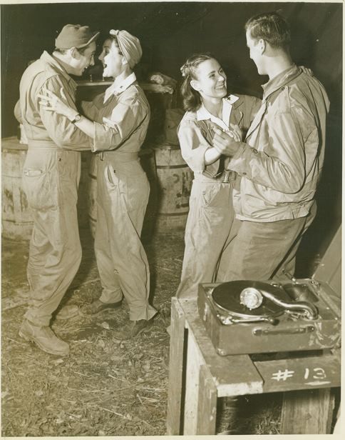 Red Cross women dancing with soldiers.