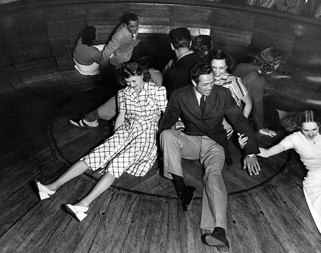 At the Venice Pier Fun House in 1940. As the bowl spins, people fight for leverage to stay in the center.