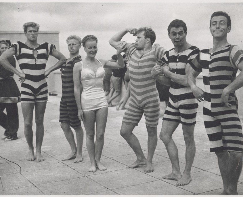 1940s men hamming it up in bathing suits.