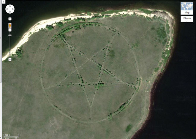 The Pentagram. Located on the windy and dusty steppes of central Asia, deep within an isolated region of Kazakhstan, this humongous pentagram measures just about 1,200 feet in diameter - deeply etched into the surface of the Earth below. Tucked away in the southern shore of the Upper Tobol Reservoir, the chilling discovery can be spotted on both Google Earth - and in greater, vivid detail on Google Maps. With the closest human habitation being over 12 miles east of the symbol - conspiracy theorists went nuts over the source of the ancient symbol. After much speculation and deliberation, it was revealed that the pentagram was initially etched into the ground due to the region's ties to Soviet Russia. Since the area is determined to be a former Soviet campground, the insignia would be marked there as stars were commonly used to decorate Soviet facades, flags and monuments.