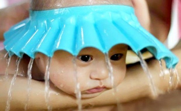 Baby Bath Umbrella Hat. (The kid doesn't seem very happy though).