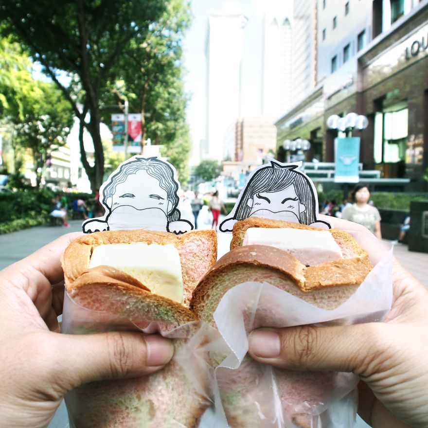 A couple wanted to have pictures of their journey but without looking like attention typical seekers. But they didn't want the photos to look like something from a travel magazine so they make these characters that represent them. This is the famous $1 Ice Cream in Orchard Road, Singapore.