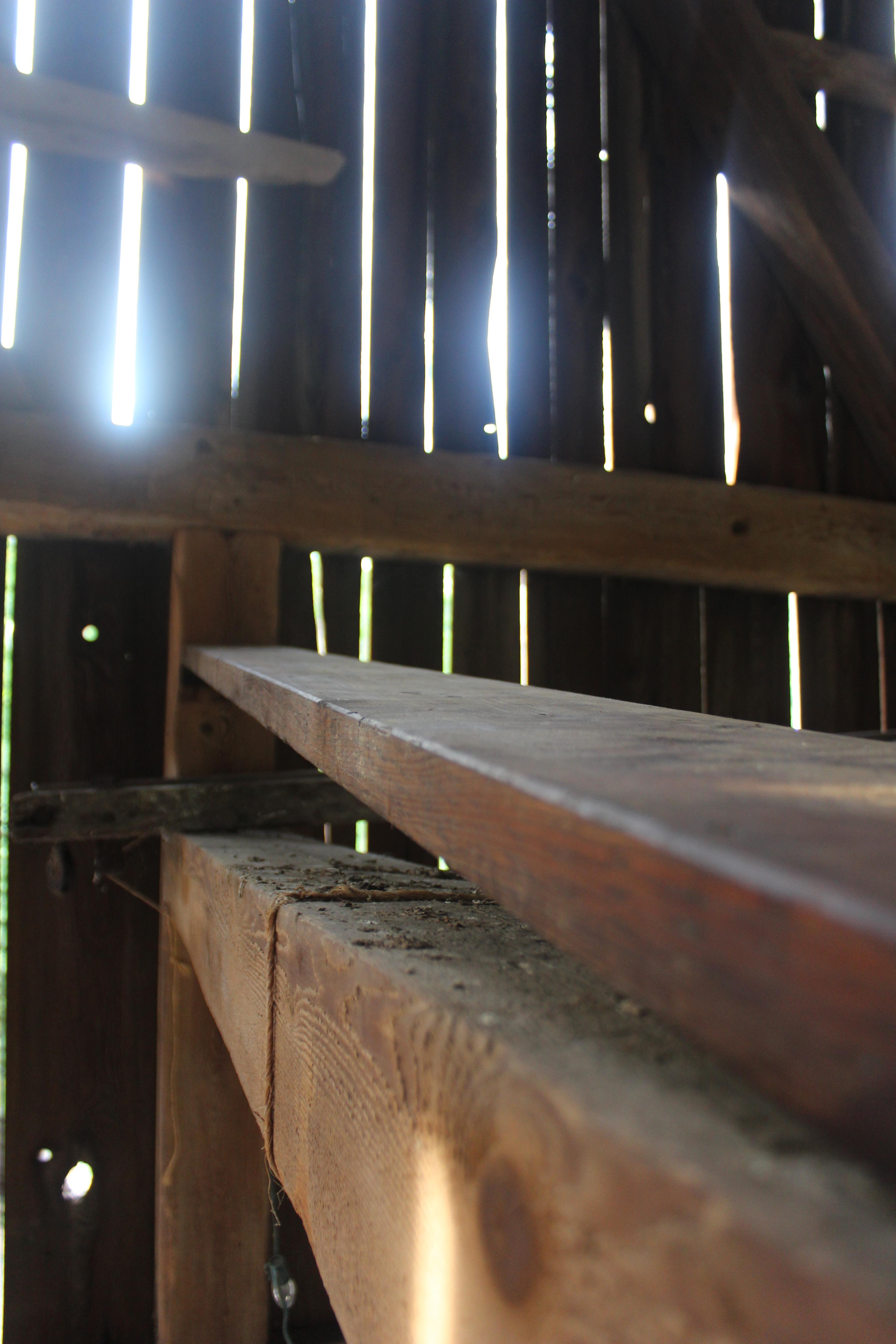 "First positioning. I cut a piece about two inches wide from the leftover board, screwed it to the beam in the back and then screwed the board to that prop piece, as well as screwing the low end of the board into the beam. Just for safety."