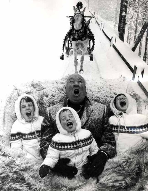 Alfred Hitchcock eating snow with his three granddaughters, Mary, Tere, and Katie, 1960s.