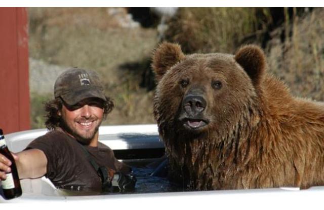 Man in a hot tub with a bear in Montana