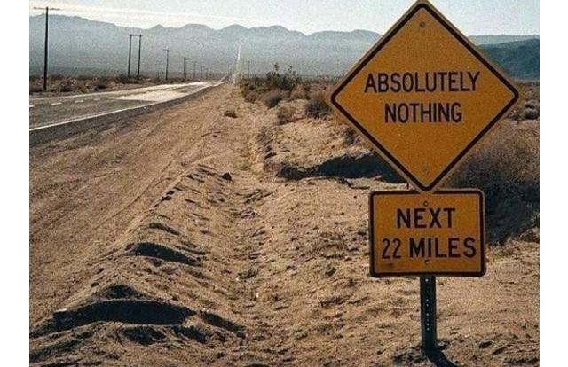 Sign on the side of the road saying 'Absolutely Nothing next 22 Miles
