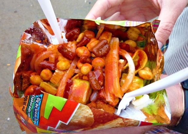 Mexico. Tostilocos are now commonly sold in Mexican movie theatres and at stadiums. This street food traditionally consists of tortilla chips topped with hot sauce, cucumber, jícama, lime juice, beans, and peanuts.