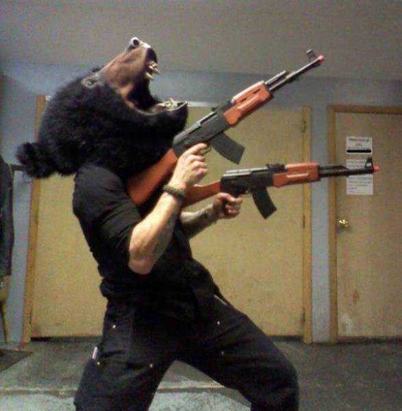 russia - person wearing a bear mask and holding guns