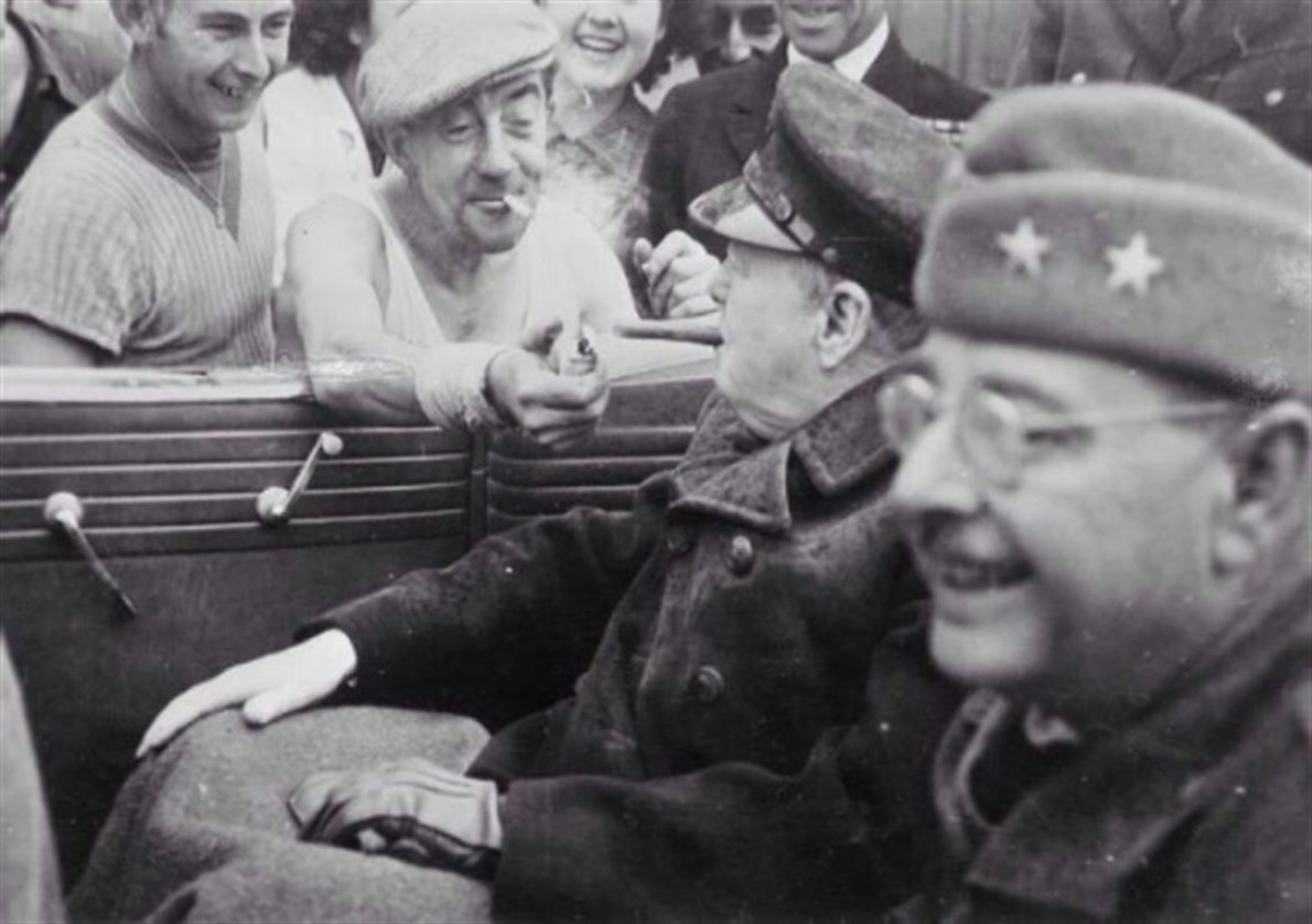 Winston Churchill getting his cigar lit by a random person on the street.