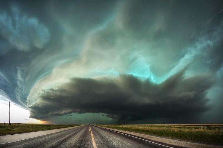 Storm clouds menace a highway, leading to a tornado near Stratford, Texas.   Open Nature category.