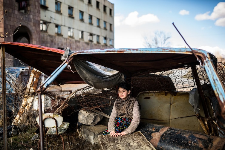 An Armenian girl sits in a makeshift shelter.   Professional Daily Life category.