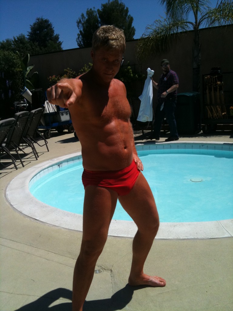 Alan Tudyk posing for the camera while hanging out at a hotel pool in 2011 before shooting a scene.