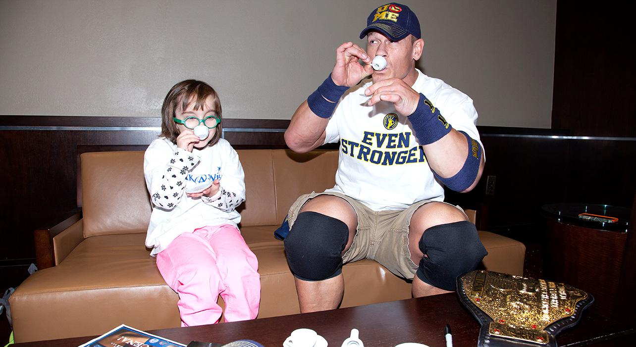 John Cena having a tea party with a little girl with a life-threatening neurological disorder for the Make-A-Wish Foundation in 2014.